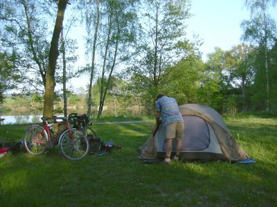 A small camping with a fishing pond, we the only campers, a few caravans and birds such as the nightingale