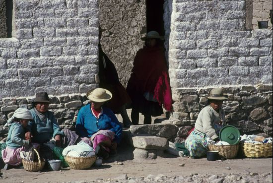 Quechua women in Bolivia selling rolls and soup on a roadcrossing